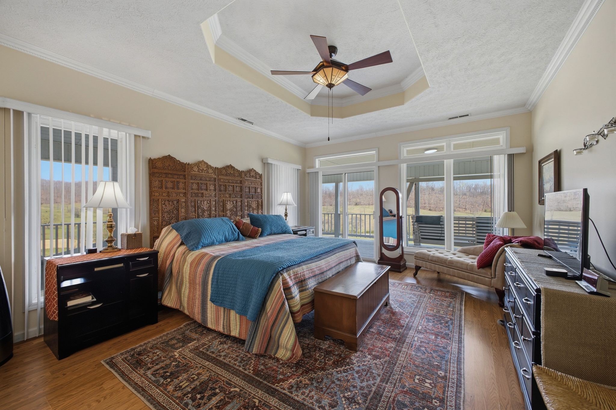 Primary bedroom with tray ceiling and valley views
